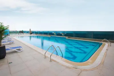 a large swimming pool on top of a building at Studio Apartment featuring Alexa in Elite Residence - Allsopp & Allsopp in Dubai