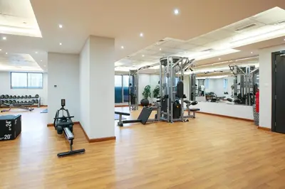 a gym with treadmills and machines in a room at Studio Apartment featuring Alexa in Elite Residence - Allsopp & Allsopp in Dubai