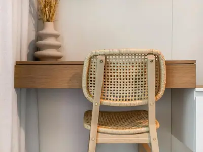 a wicker chair sitting on top of a wooden shelf at Cozy One Bedroom on the Beach in Dubai Harbour - Prestige Retreats in Dubai