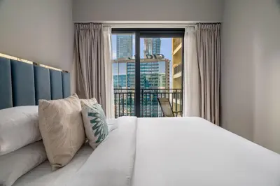 a bedroom with a large bed and a large window at GuestReady - Business Bay delight in Dubai