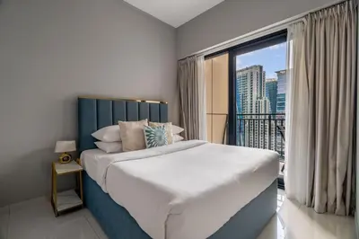 a bedroom with a large bed and a large window at GuestReady - Business Bay delight in Dubai