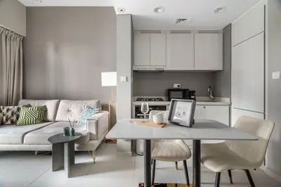 a living room and kitchen with a table and a couch at GuestReady - Business Bay delight in Dubai