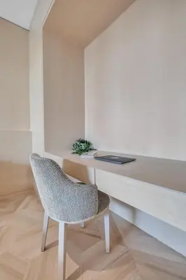 a chair sitting next to a desk in a room at Palm Haven Luxe 3 Bed Townhouse with Private Pool in Dubai