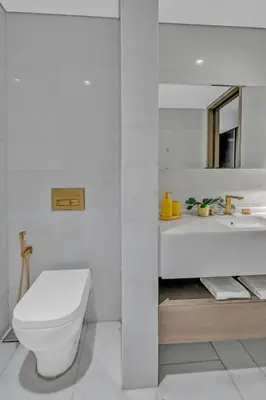 a white bathroom with a toilet and a sink at Palm Haven Luxe 3 Bed Townhouse with Private Pool in Dubai