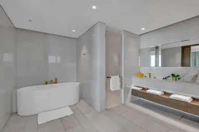 a white bathroom with a tub and a sink at Palm Haven Luxe 3 Bed Townhouse with Private Pool in Dubai