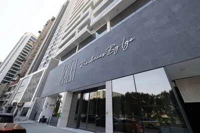 a building with a sign on the side of it at Cozy Boho Retreat One Bedroom Sanctuary in Dubai