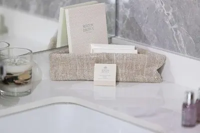 a table with a box of tissues and a candle at Cozy Boho Retreat One Bedroom Sanctuary in Dubai