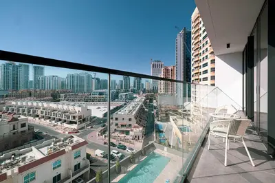 a balcony with a view of a city at Cozy Boho Retreat One Bedroom Sanctuary in Dubai