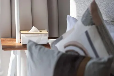 a close up of a bed with a brush on a table at Cozy Boho Retreat One Bedroom Sanctuary in Dubai
