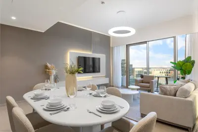 a dining room with a white table and chairs at Elegant Retreat with Stunning Burj Khalifa Views in Dubai