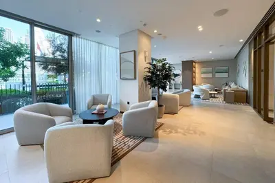 a living room with chairs and a table in a building at Elegant Retreat with Stunning Burj Khalifa Views in Dubai