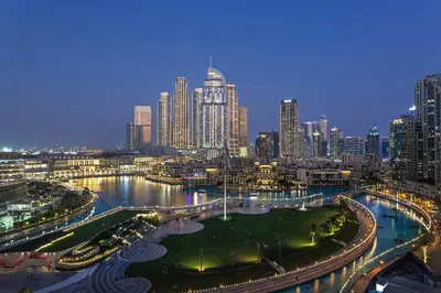 a view of a city skyline at night at Elegant Retreat with Stunning Burj Khalifa Views in Dubai