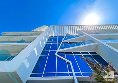 a staircase on the side of a building with blue tiles at Modern 1B with Balcony, Gym & Pool Access in Dubai