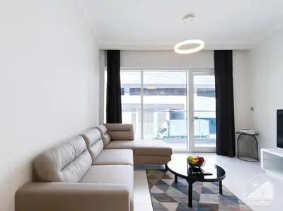 a living room with a couch and a table at Modern 1B with Balcony, Gym & Pool Access in Dubai