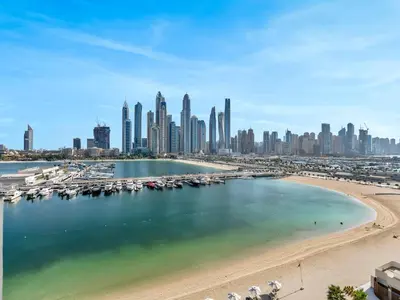 a view of a city with a beach and buildings at Designer Large 1 BR with Private Beach Infinity pool in Dubai Harbour in Dubai