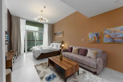 a living room with a couch and a table at Business Bay Gem , Burj Khalifa View in Dubai