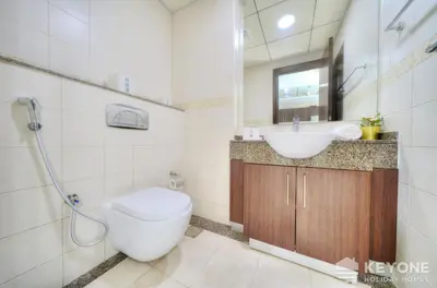a bathroom with a toilet and a sink at Contemporary One Bedroom with Full Marina View in Dubai