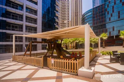 a park with a playground in a city at Contemporary One Bedroom with Full Marina View in Dubai
