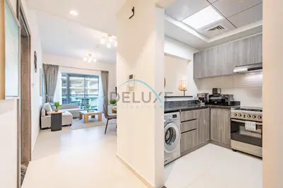 a kitchen and living room in a apartment at Charming 1BR in Orchid Residence, Al Barsha South by Deluxe Holiday Homes in Dubai