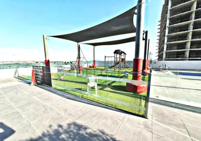 a tent on a pier with a playground at Charming 1BR in Orchid Residence, Al Barsha South by Deluxe Holiday Homes in Dubai