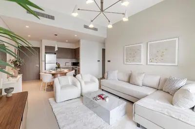 a living room with a white couch and a table at 1BR Act One Act Two T2 City View Downtown in Dubai