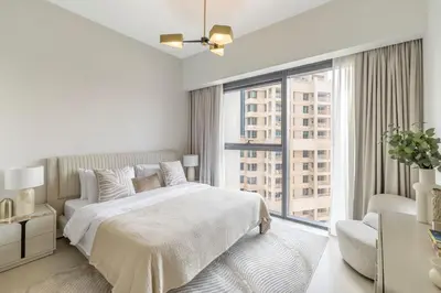 a white bedroom with a bed and a large window at 1BR Act One Act Two T2 City View Downtown in Dubai