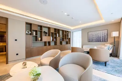 a hotel lobby with chairs and a table and a room at 1BR Act One Act Two T2 City View Downtown in Dubai