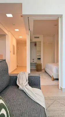 a living room with a couch and a bed at DAYF-LFT 2 BR in the heart of Downtown walking distance to Burj Khalifa Park in Dubai