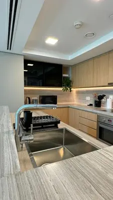 a kitchen with a sink in the middle of it at DAYF-LFT 2 BR in the heart of Downtown walking distance to Burj Khalifa Park in Dubai