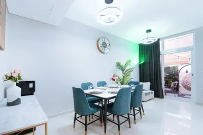 a dining room with a table and chairs at Luxurious 3BDR Serenity Awaits in Damac Hills 2 in Dubai
