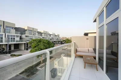 a balcony of a building with a couch on it at Luxurious 3BDR Serenity Awaits in Damac Hills 2 in Dubai