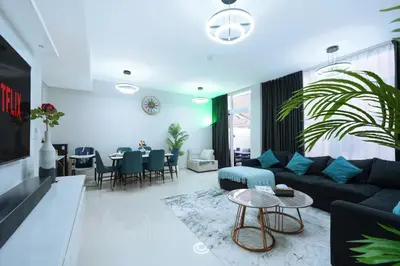 a living room with a couch and a table at Luxurious 3BDR Serenity Awaits in Damac Hills 2 in Dubai