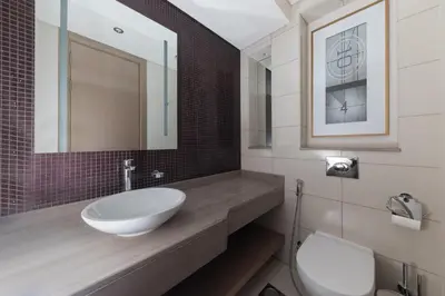 a bathroom with a sink and a toilet at Cozy 1BR with balcony great view, Damac Towers in Dubai