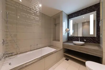 a bathroom with a tub and a sink at Cozy 1BR with balcony great view, Damac Towers in Dubai