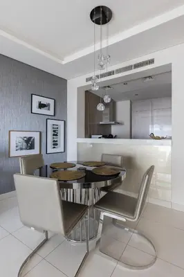 a dining room with a table and chairs at Cozy 1BR with balcony great view, Damac Towers in Dubai