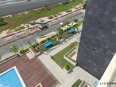 an overhead view of a courtyard with a swimming pool at Modern Contemporary Studio in Azizi Riviera in Dubai