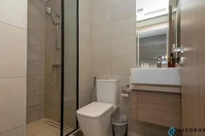 a bathroom with a toilet and a sink and a shower at Modern Contemporary Studio in Azizi Riviera in Dubai