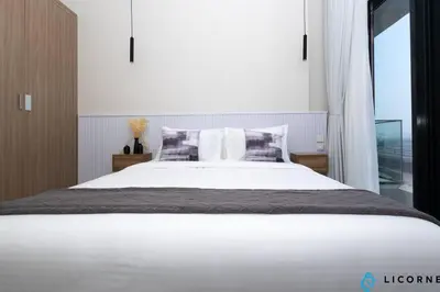 a bedroom with a large white bed and a window at Modern Contemporary Studio in Azizi Riviera in Dubai