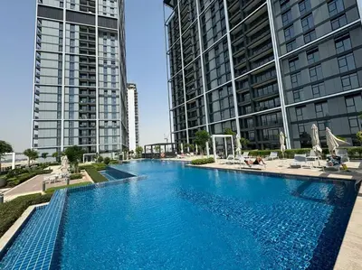 a large swimming pool with two tall buildings at Stunning 1BDR with Resort Style in Creek Harbour in Dubai