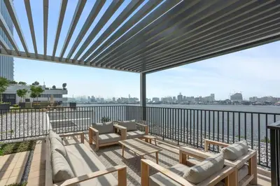 a patio with a view of the water at Stunning 1BDR with Resort Style in Creek Harbour in Dubai
