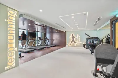 a gym with treadmills and cardio equipment in a building at Stunning 1BDR with Resort Style in Creek Harbour in Dubai