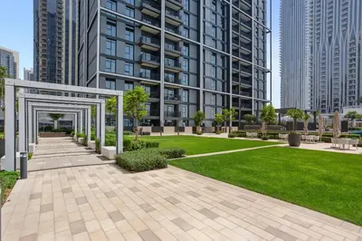 a park in the middle of a city with tall buildings at Stunning 1BDR with Resort Style in Creek Harbour in Dubai