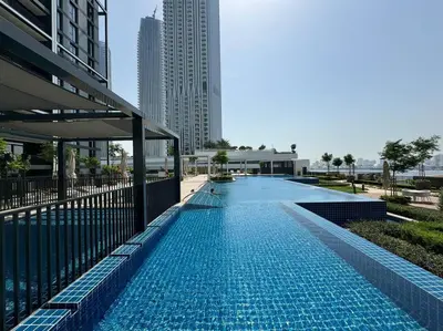 a swimming pool in the middle of a building at Stunning 1BDR with Resort Style in Creek Harbour in Dubai