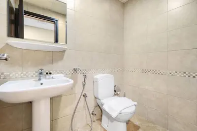 a bathroom with a white toilet and a sink at FIRST CLASS 1BR Charming Marina Escape in Dubai
