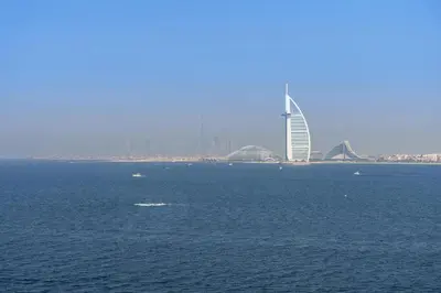 a large body of water with a building in the background at Dejaview Stays Luxury Apartment with Private Terrace, Burj & Sea View in Dubai