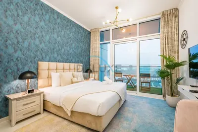 a bedroom with a large bed and a large window at Chic Studio in Damac Hills Carson B, Dubailand by Deluxe Holiday Homes in Dubai