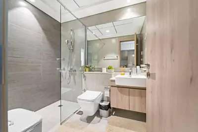 a bathroom with a toilet and a sink and a shower at Modern Studio Near To Park in Dubai