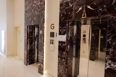 a room with black marble walls and a display case at Cozy Studio Business Bay in Dubai