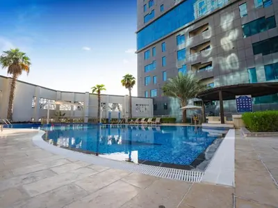 a large swimming pool in front of a building at Cozy Studio Business Bay in Dubai