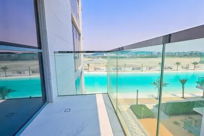 an external view of a building with a swimming pool at 1BR Close to Crystal Lagoon in District One Meydan in Dubai